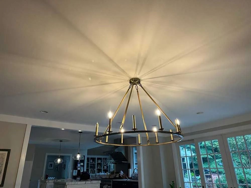 A person is using a multimeter to test an electrical outlet.