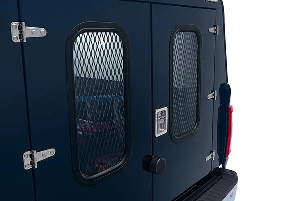 A dark blue vehicle rear door featuring two windows with protective metal mesh grilles and silver hinges.