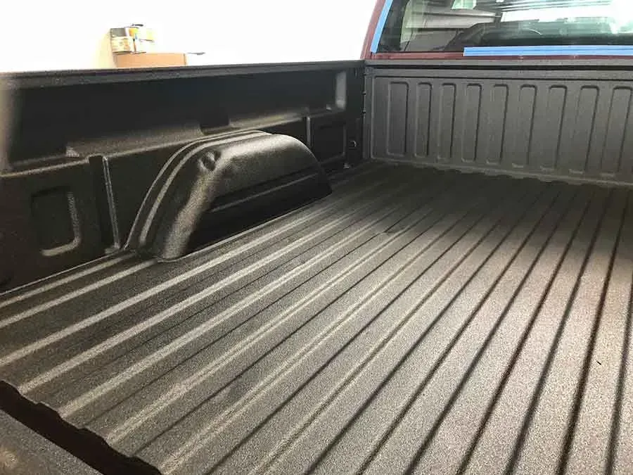 Black truck bed with textured lining.