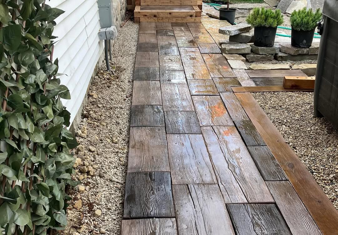 A wooden walkway is being built in the backyard of a house.