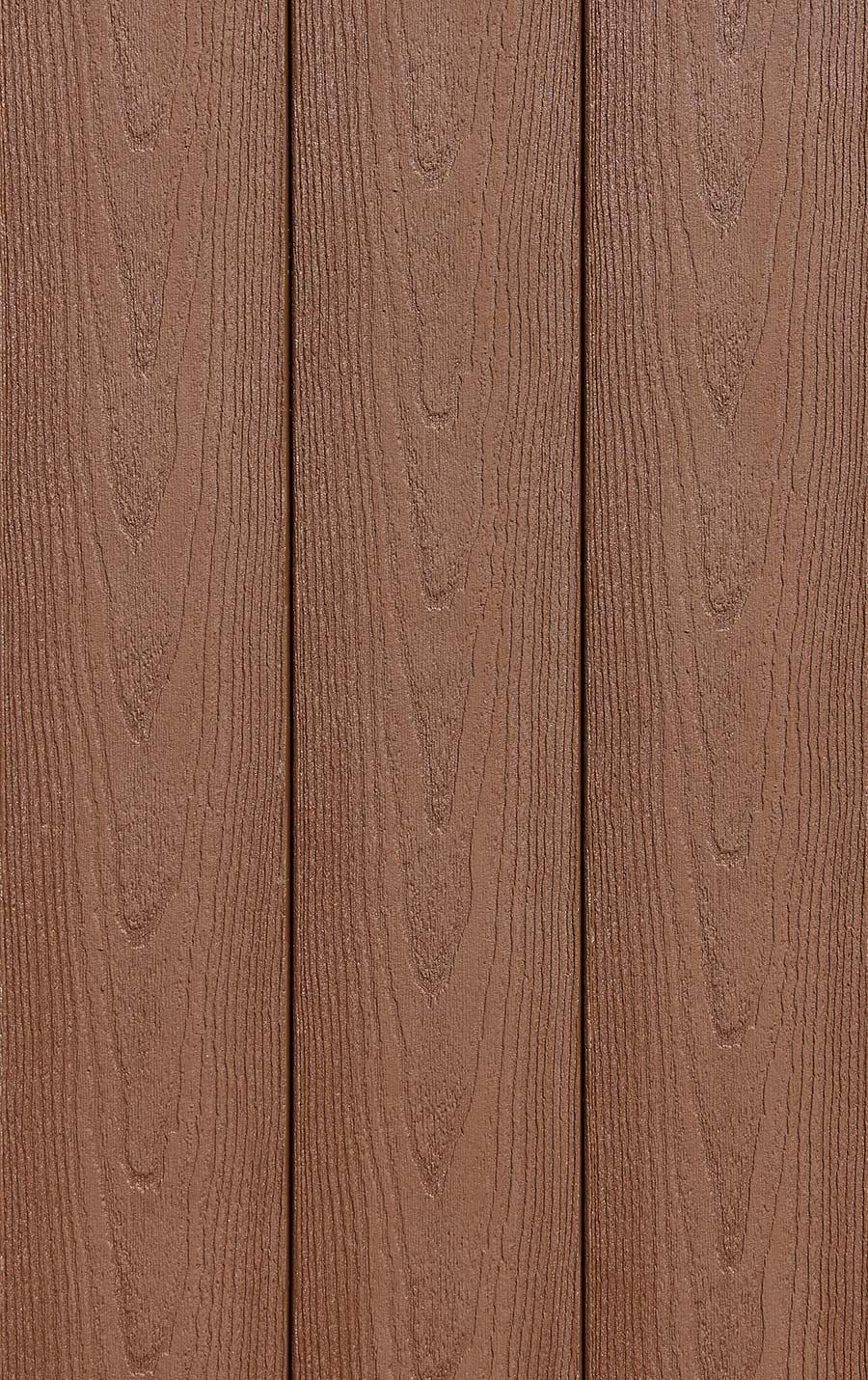 A close up of a brown wooden wall with a grainy texture.