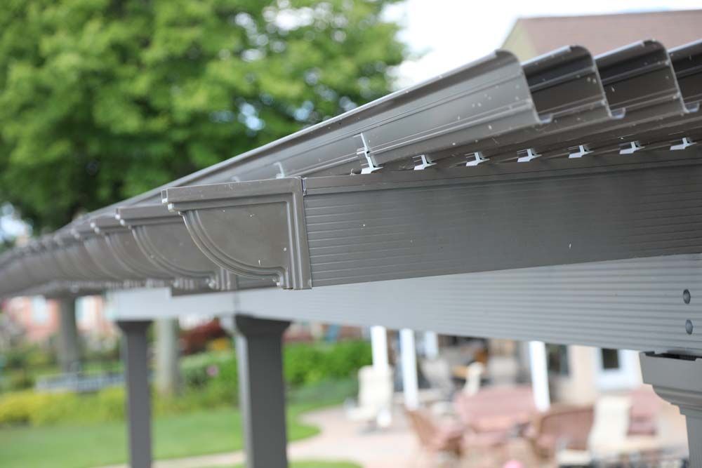 Close-up of a brown pergola roof with a decorative edge.