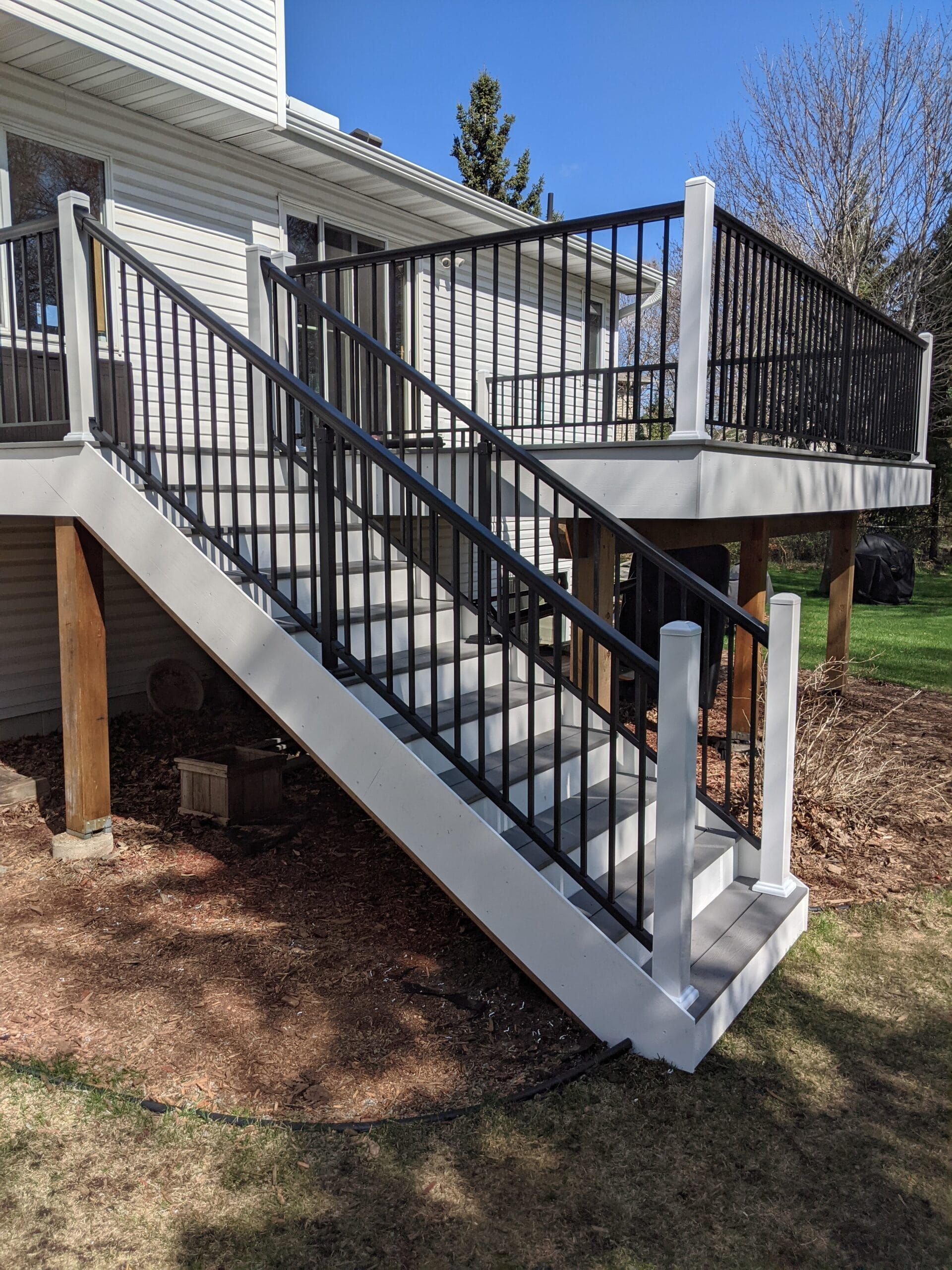 A white deck with stairs leading up to it