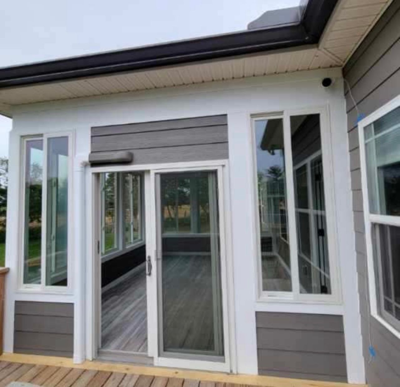 A house with a lot of windows and a sliding glass door
