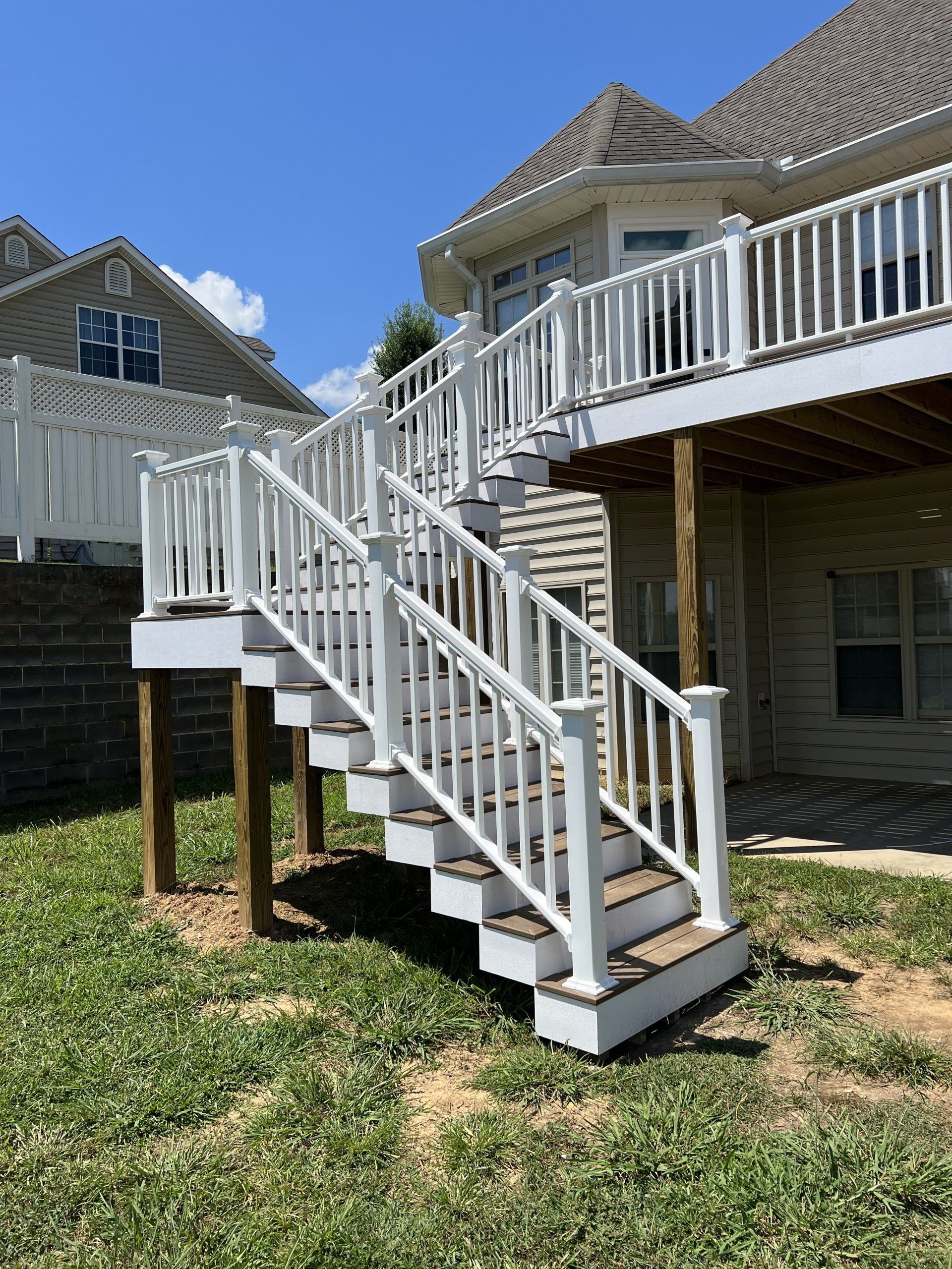 A white deck with stairs leading up to it