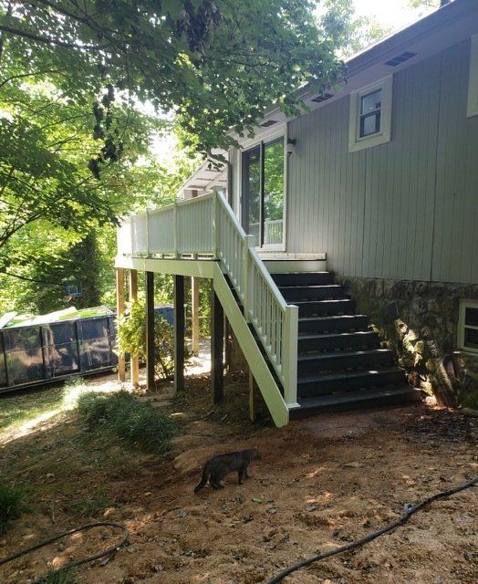 A house with a deck and stairs leading up to it