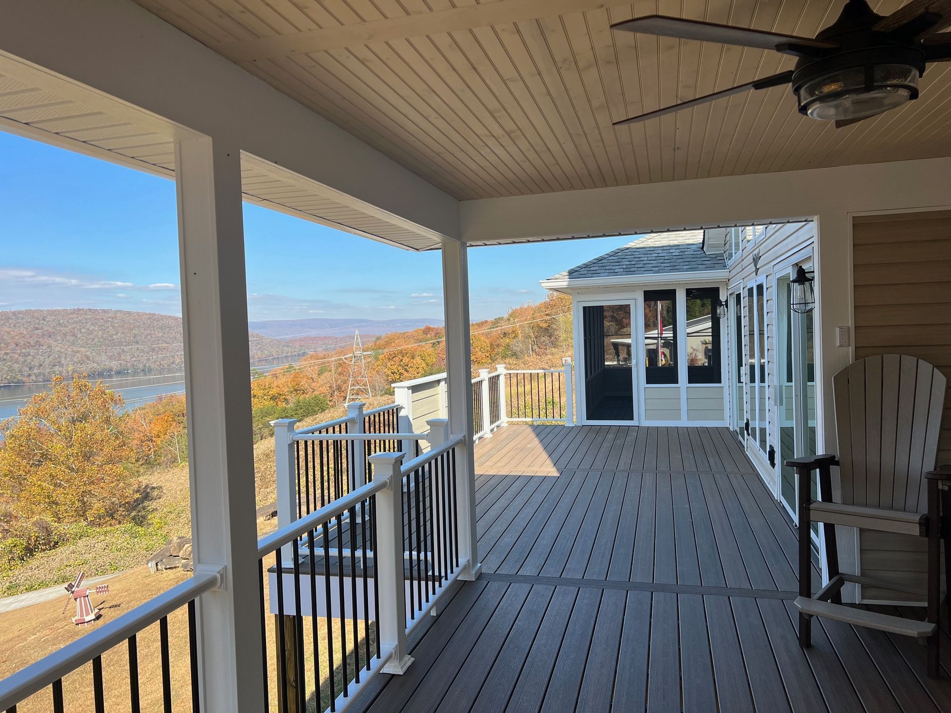 A large porch with a view of a lake