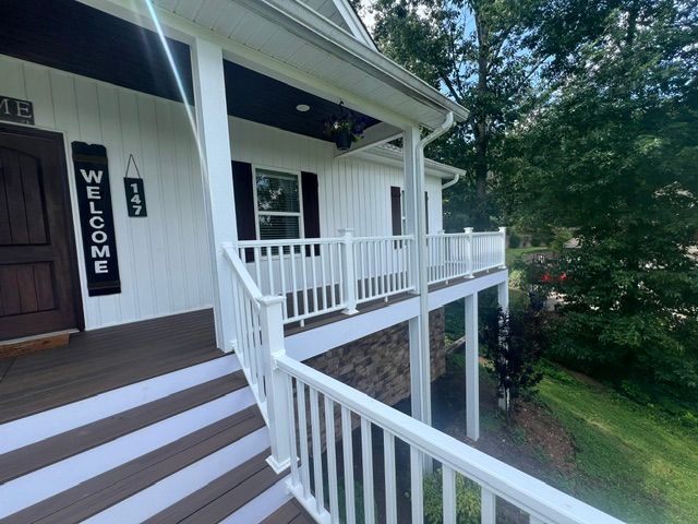 A white house with a welcome sign on the front door