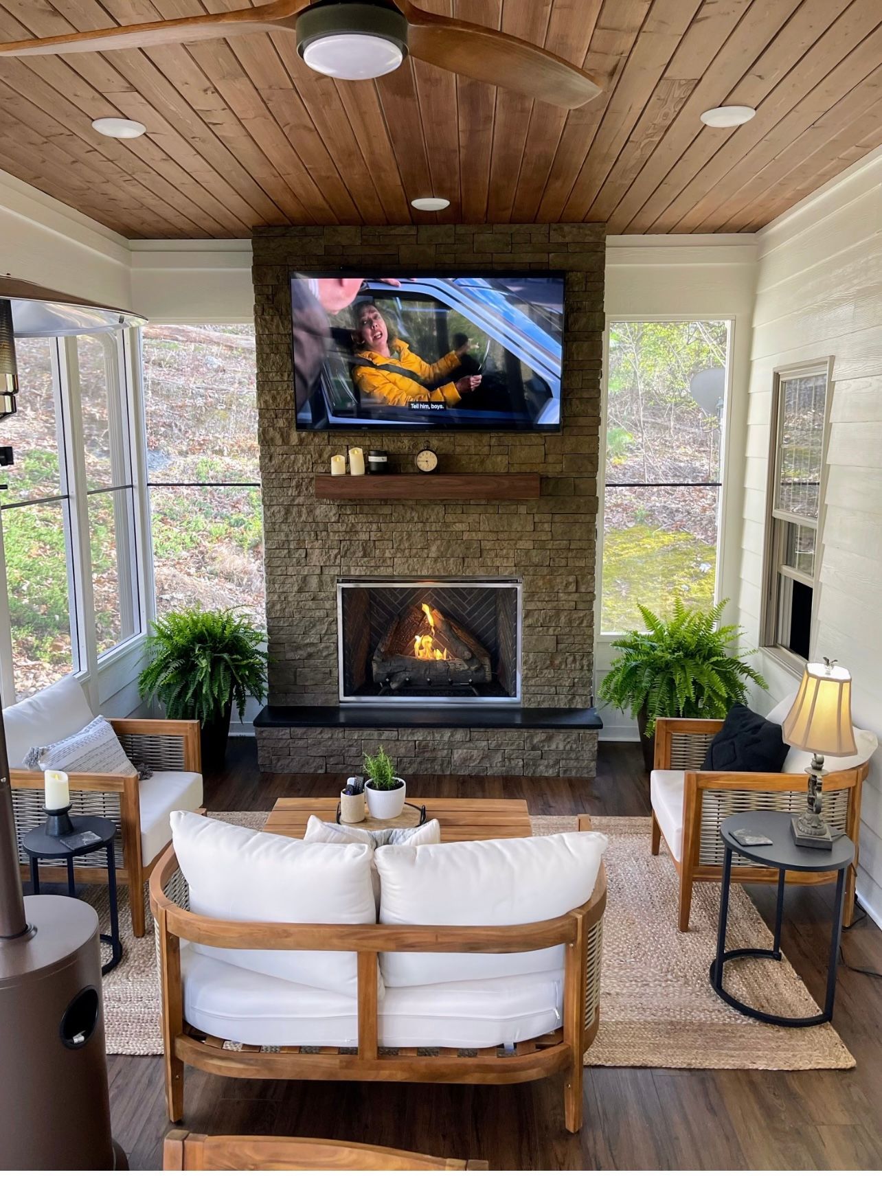 A living room with a fireplace and a flat screen tv.