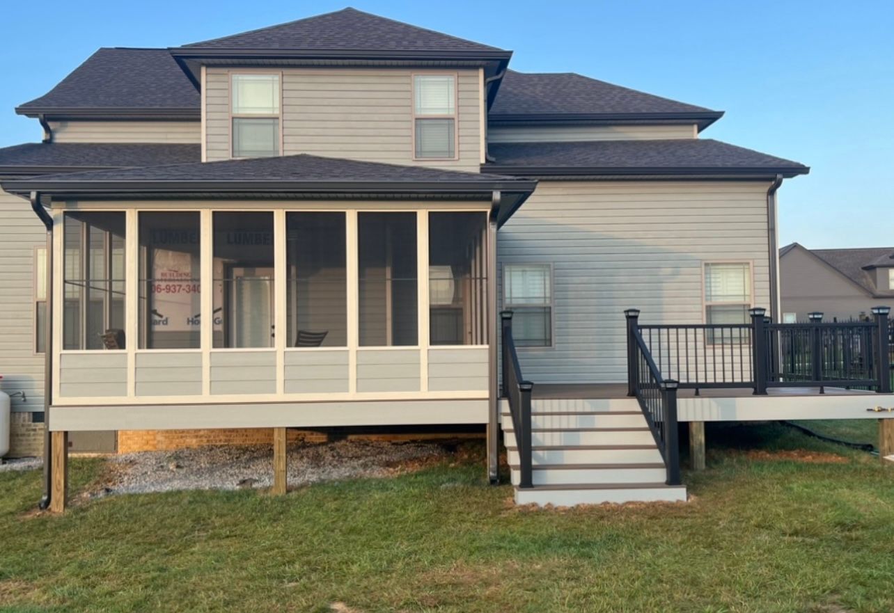 A house with a screened in porch and a deck