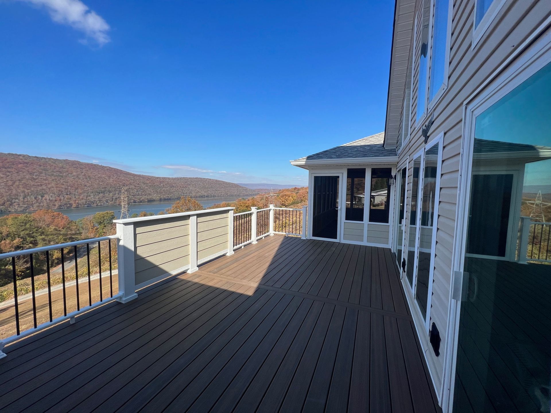 A large deck with a view of a lake