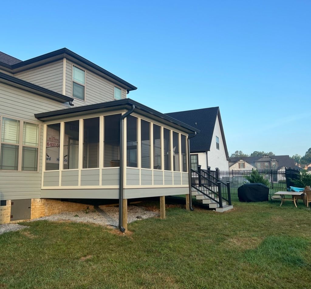 A house with a screened in porch and stairs