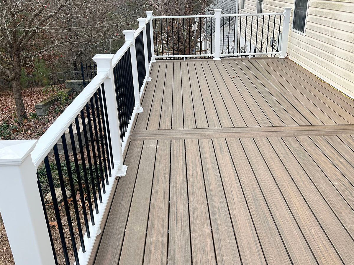 A wooden deck with a white railing