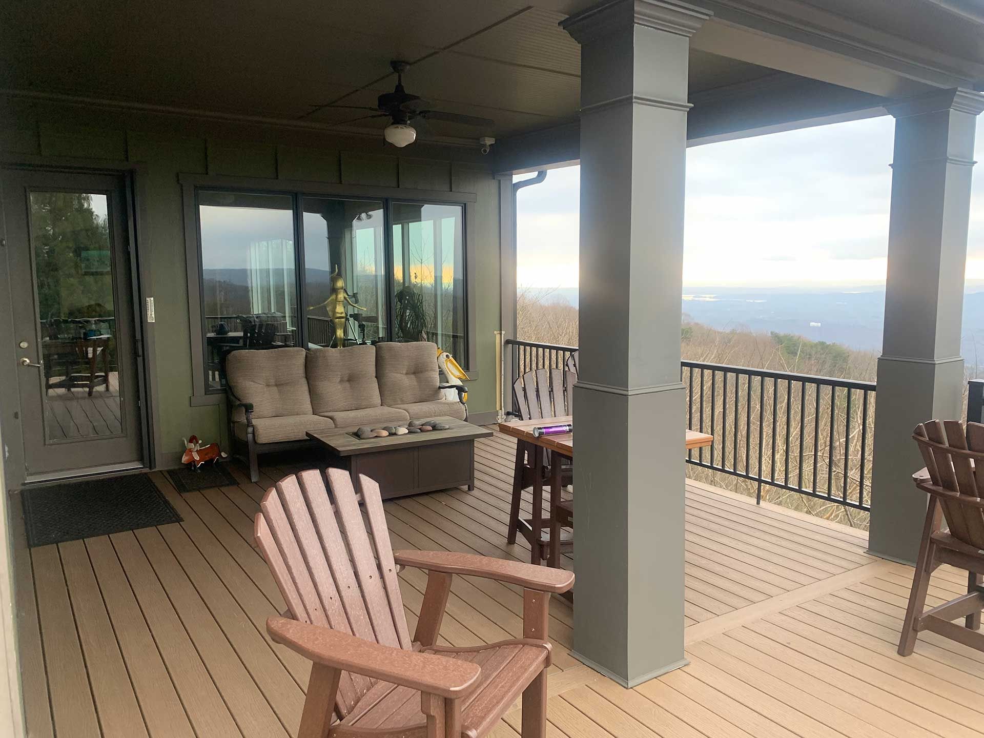 A deck with a couch and chairs on it