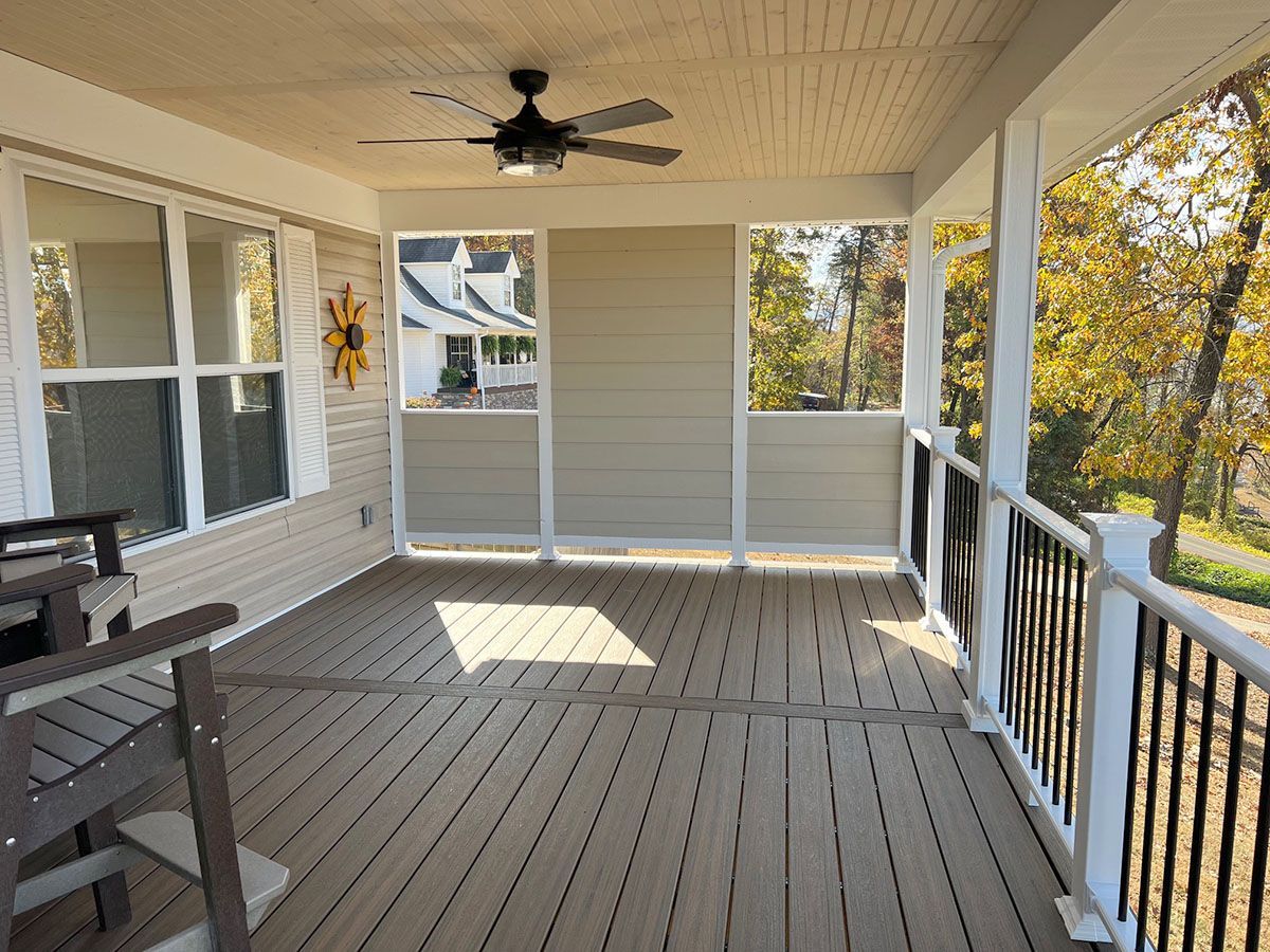 A screened porch with a ceiling fan