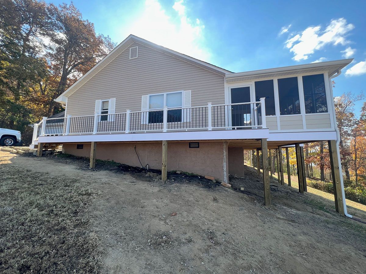 A house with a large deck and screened porch