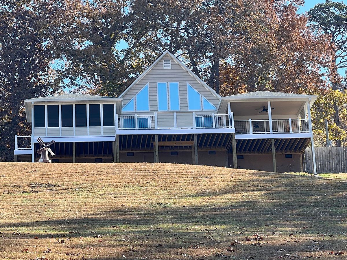 A large house with a large deck and screened porch