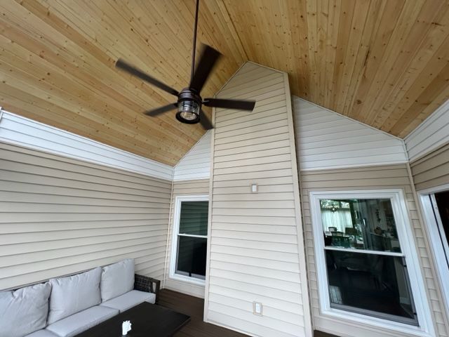 bright screened porch with ceiling fan
