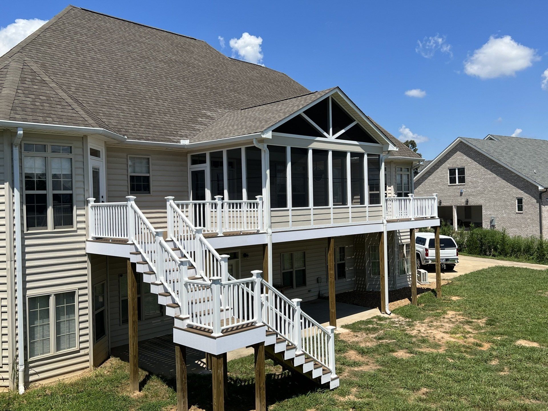 A house with a screened in porch and stairs
