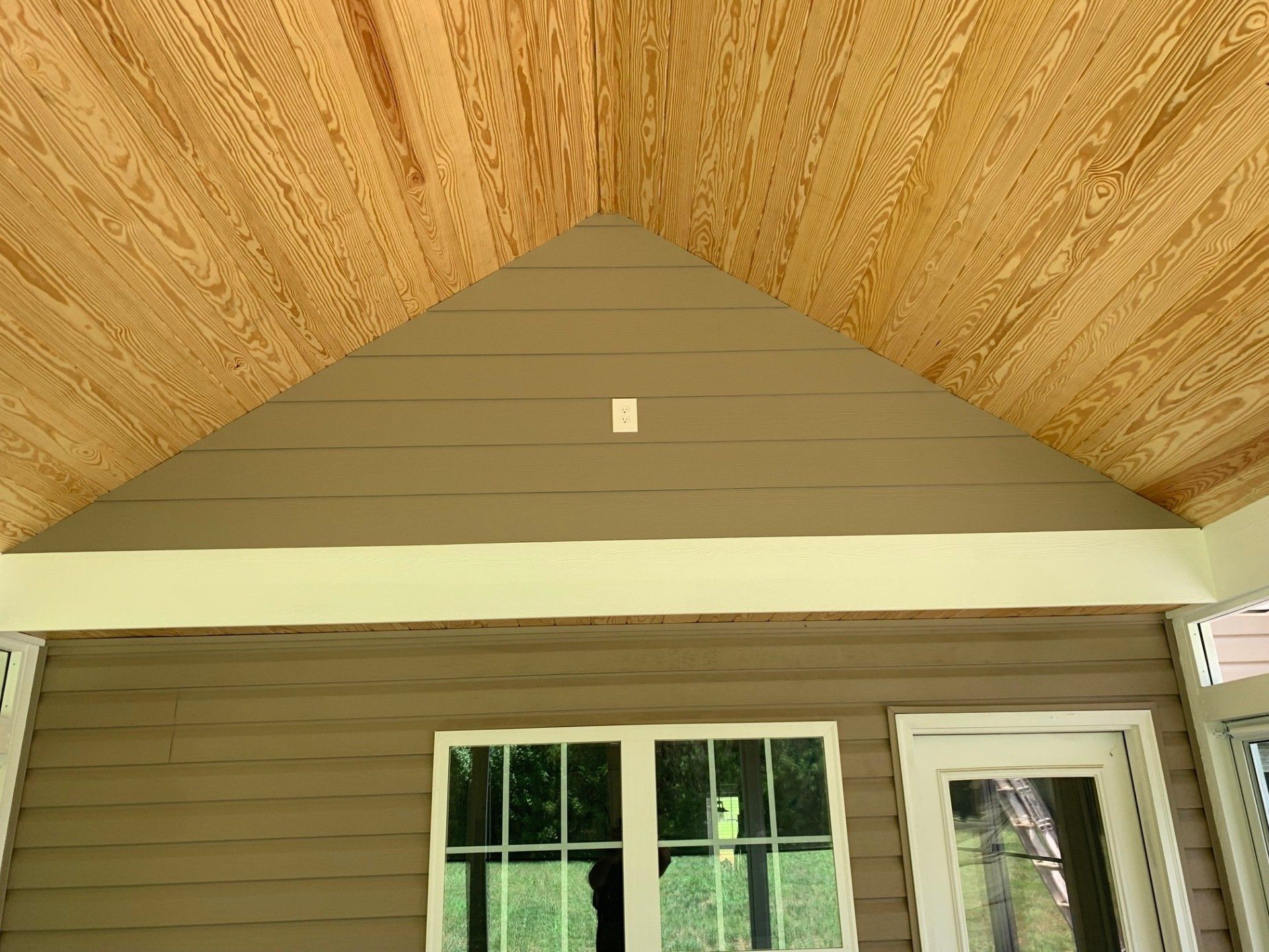 A house with a wooden ceiling and a window.