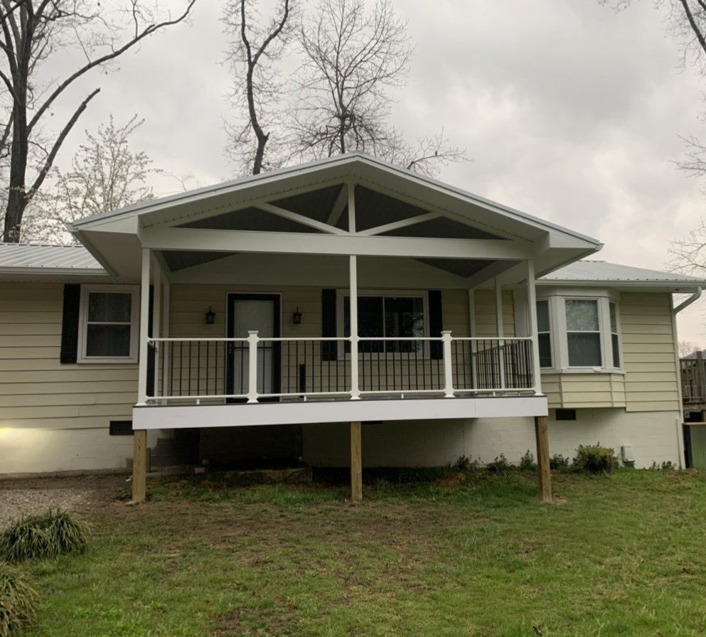 A house with a large porch and a white railing