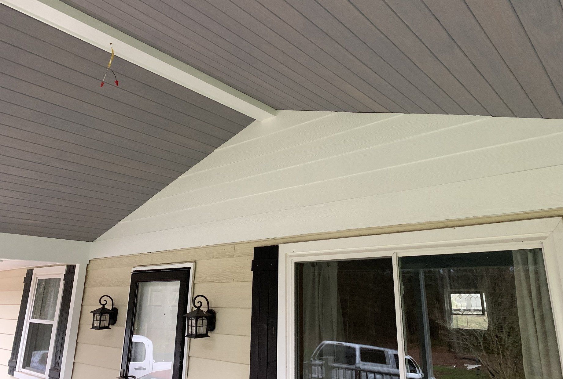 The ceiling of a house with a porch and a sliding glass door.