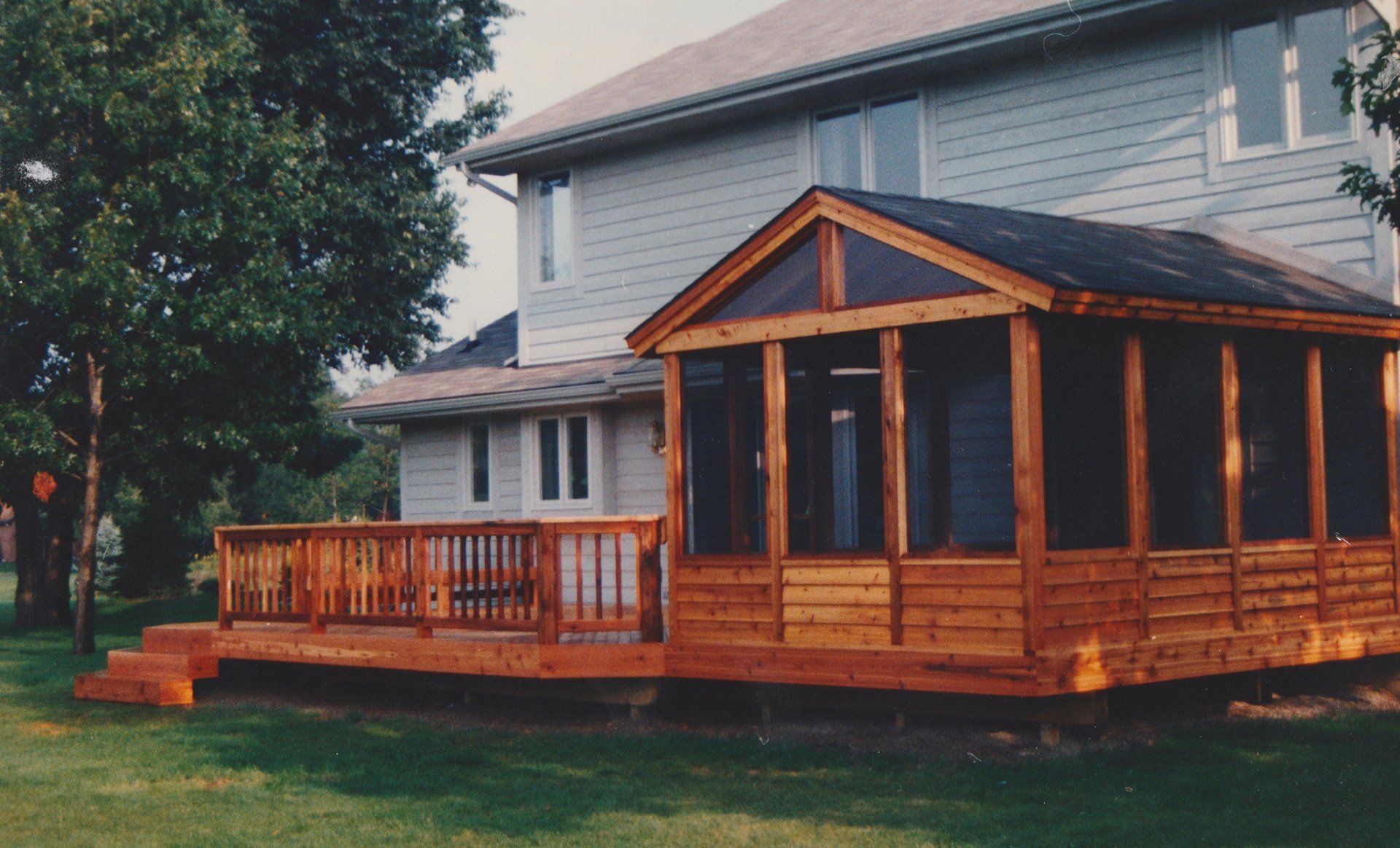A screened in porch in front of a house