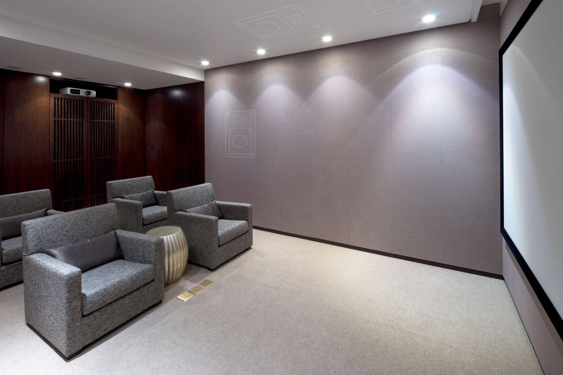 A home theater with chairs and a projector screen.