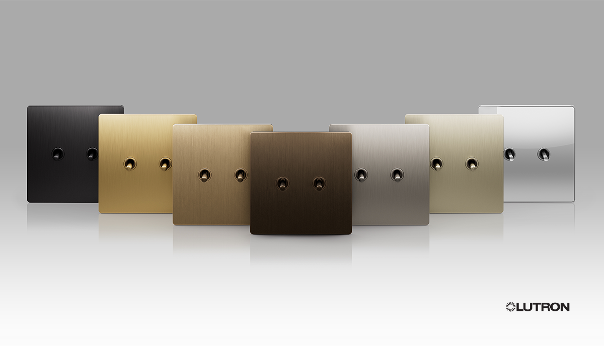 A row of different colored light switches are lined up on a table.