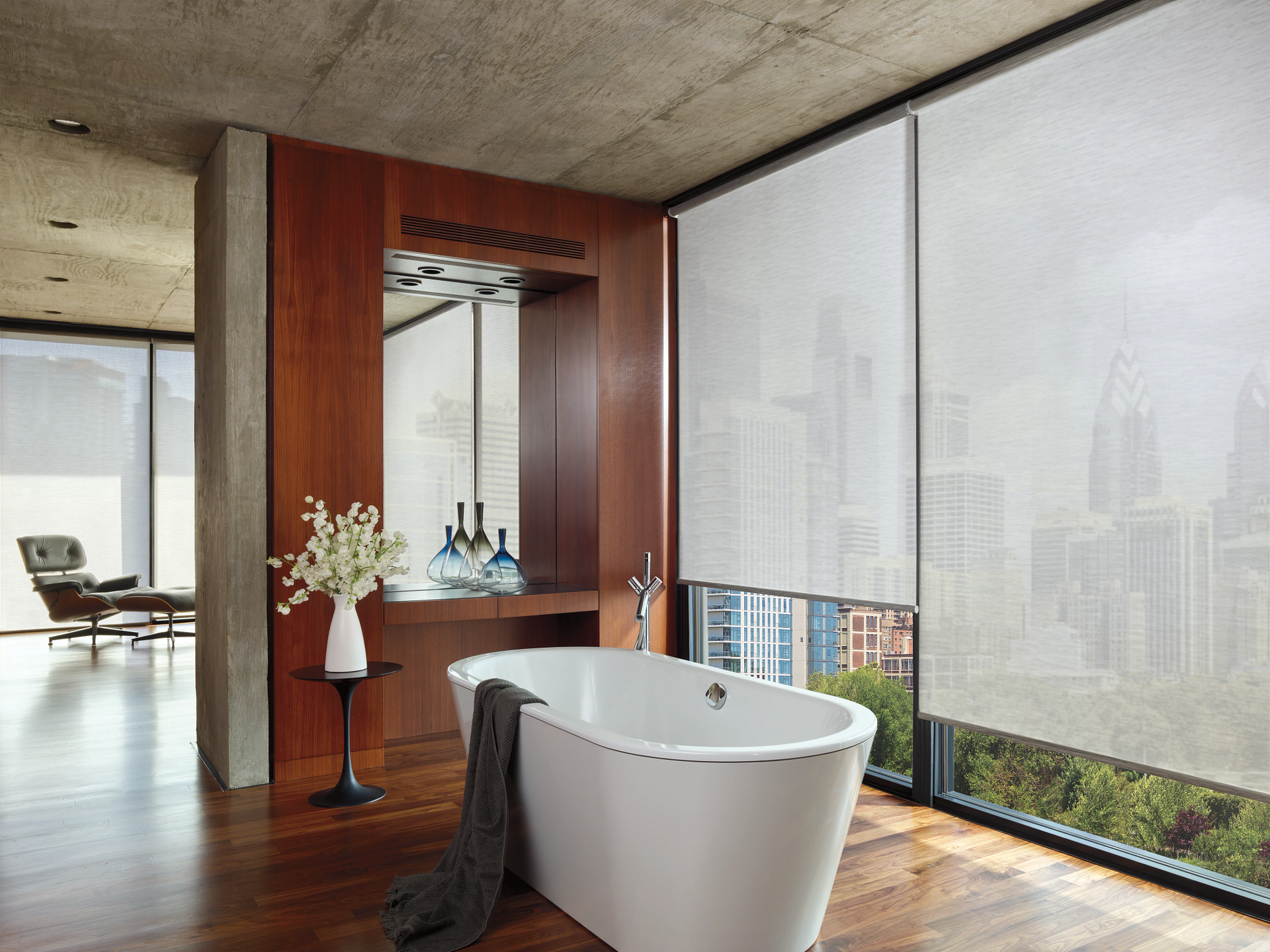 A bathroom with a bathtub and a large window.