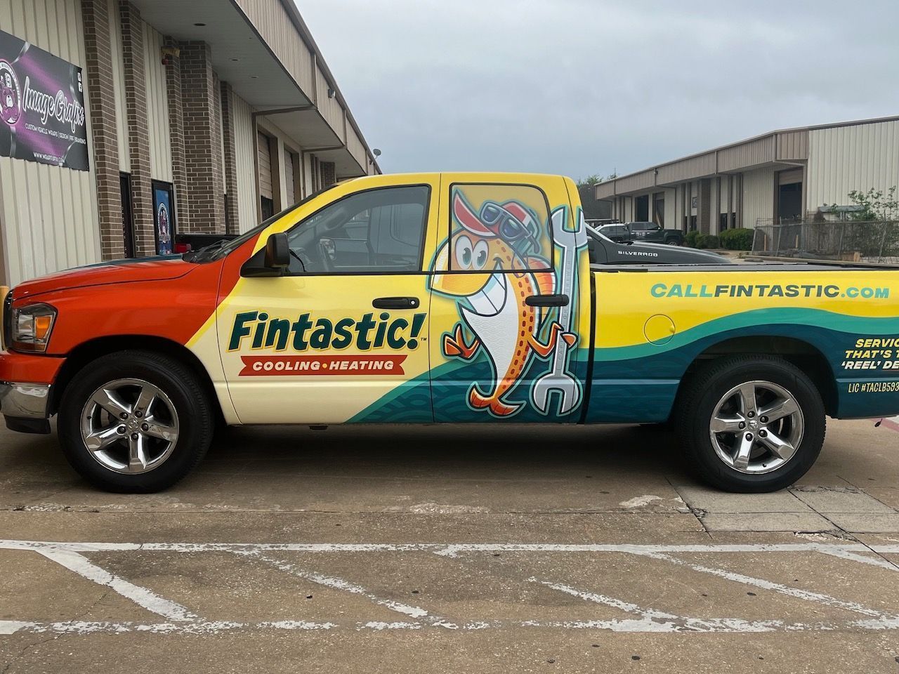 Pickup truck with Fintastic logo on the side parked outside a commercial building