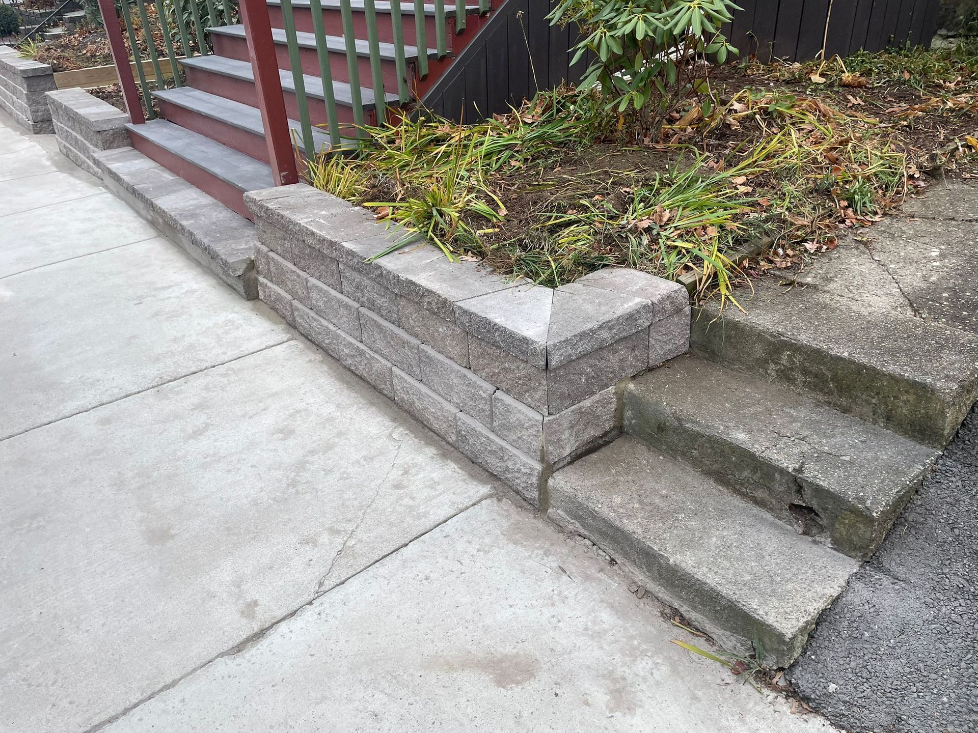 Pavers being installed on a patio, with stacks of bricks and gravel visible.