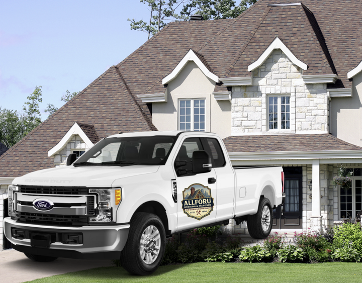 White Ford pickup truck parked in front of a house. The truck has a logo on the door.