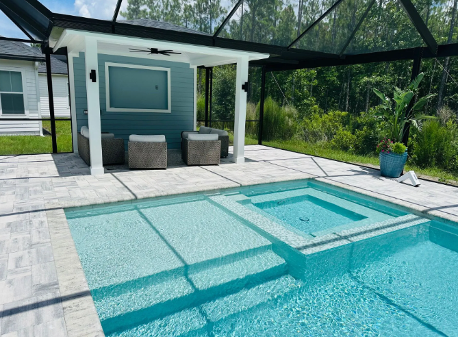 Swimming pool with attached spa, outdoor seating area under a pergola.