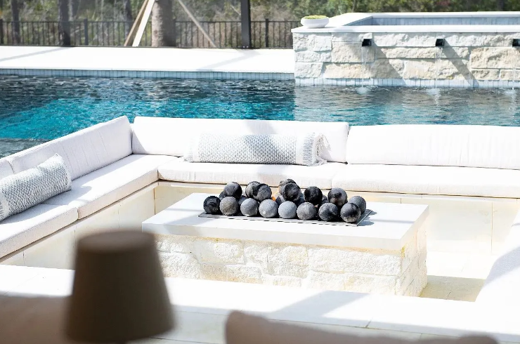 Outdoor seating area with a pool and a fire pit.