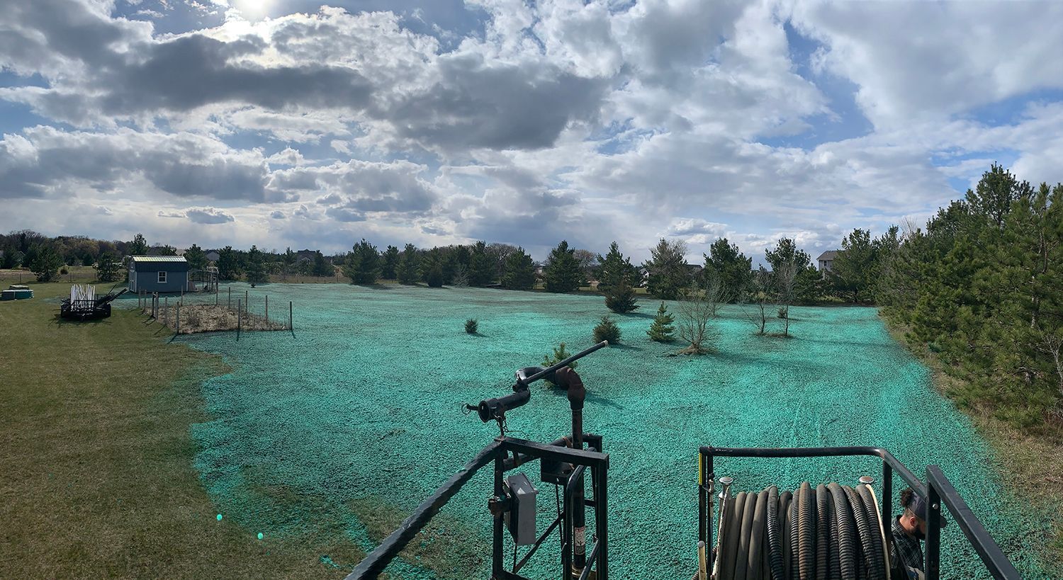A sprinkler is sitting in the middle of a field of green grass