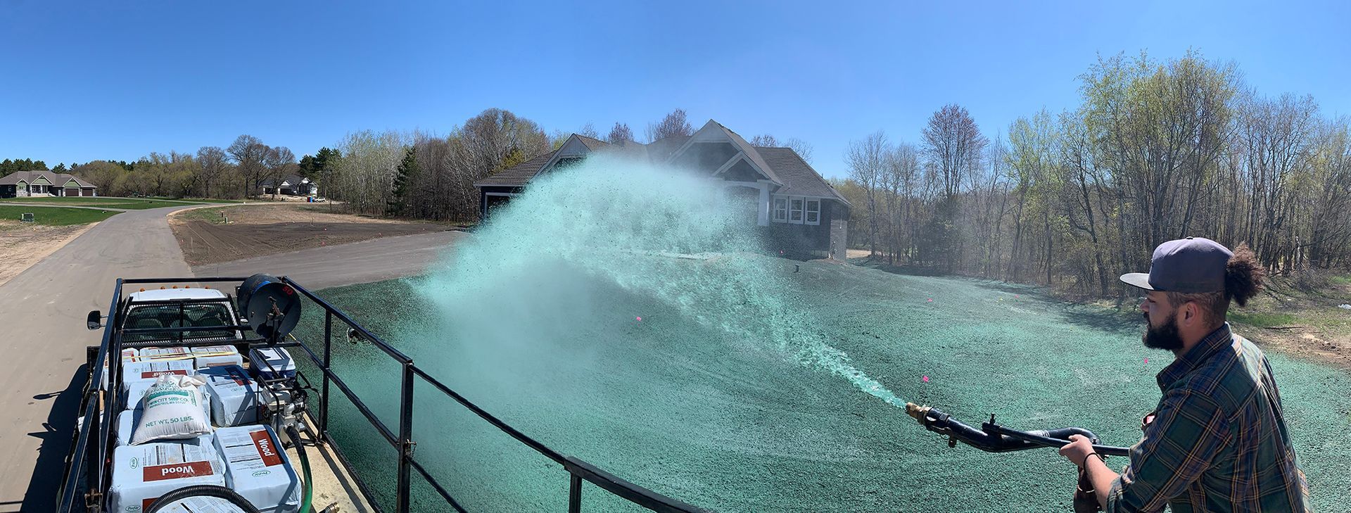 A man is spraying green on a field