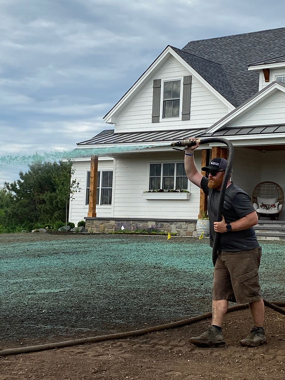 A person is spraying a lawn with a hose