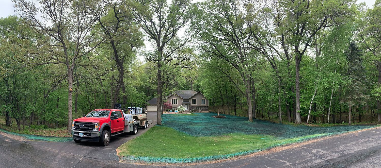 A red truck is parked in a driveway next to a house