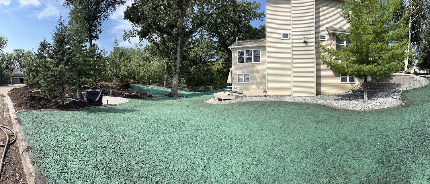 A house with a lot of green grass in front of it