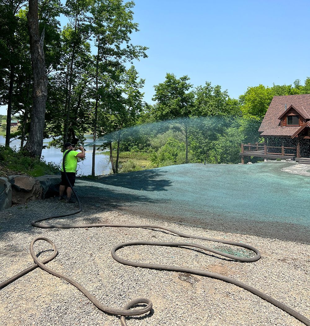 A man spraying on driveway