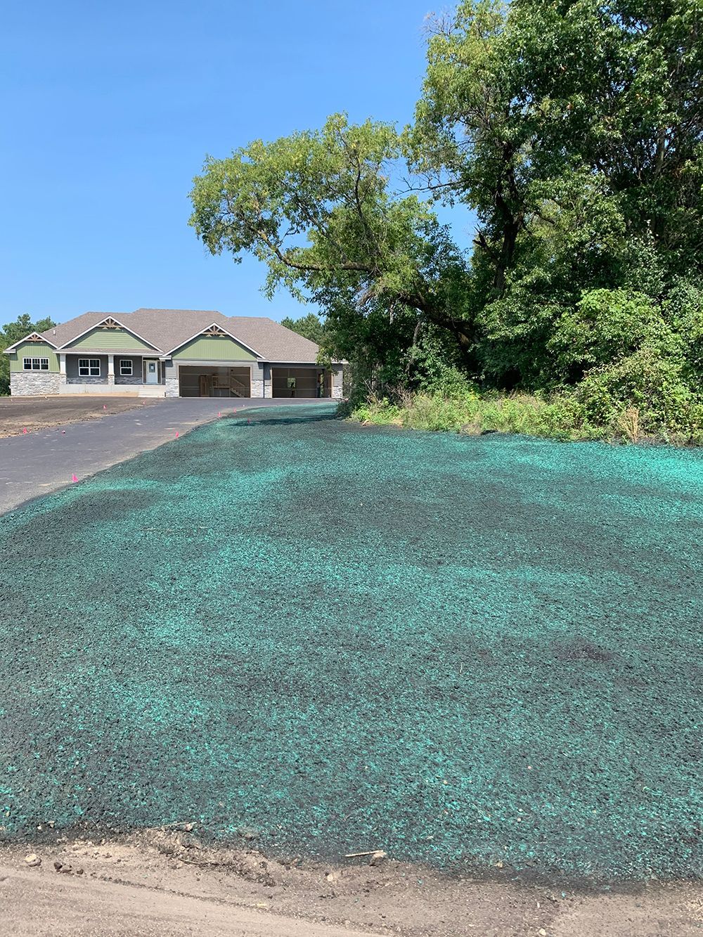 A house is sitting on top of a lush green field