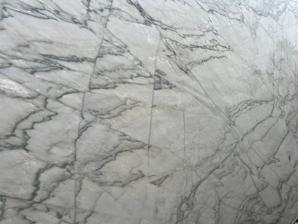 Gray marble wall with white veining and a vertical seam