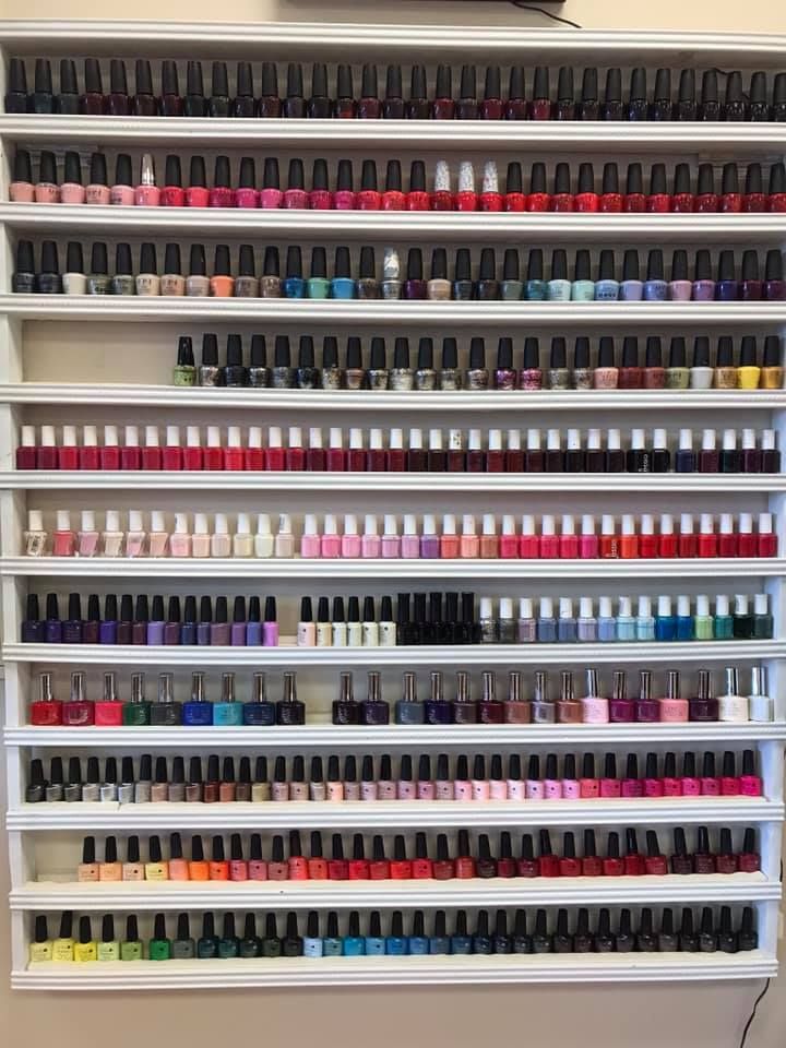 There are many different types of nail polish on the shelves.