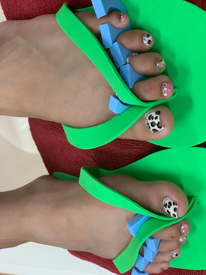 A pair of green flip flops on a person 's feet