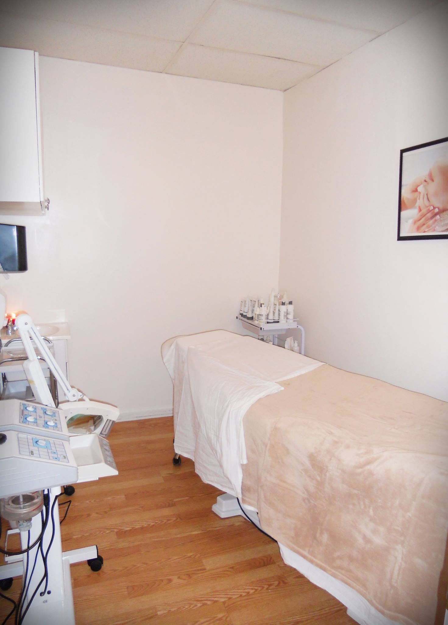 A room with a bed and a picture on the wall.