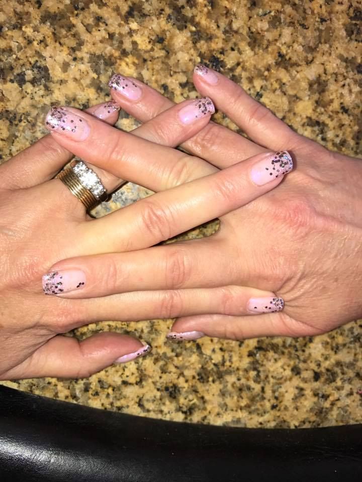A close up of a woman 's hands with a ring on her finger.