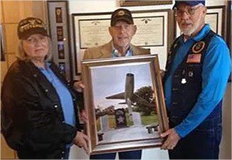 David Goode accepts pictures of Vietnam Veteran's Memorial