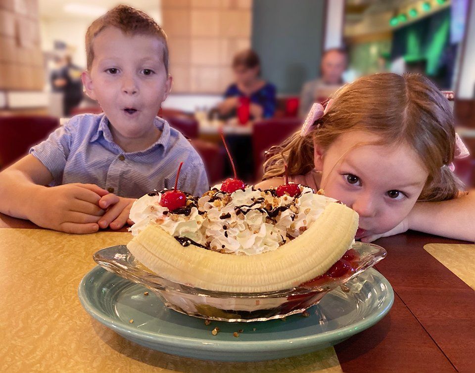 Excited children looking at their banana split
