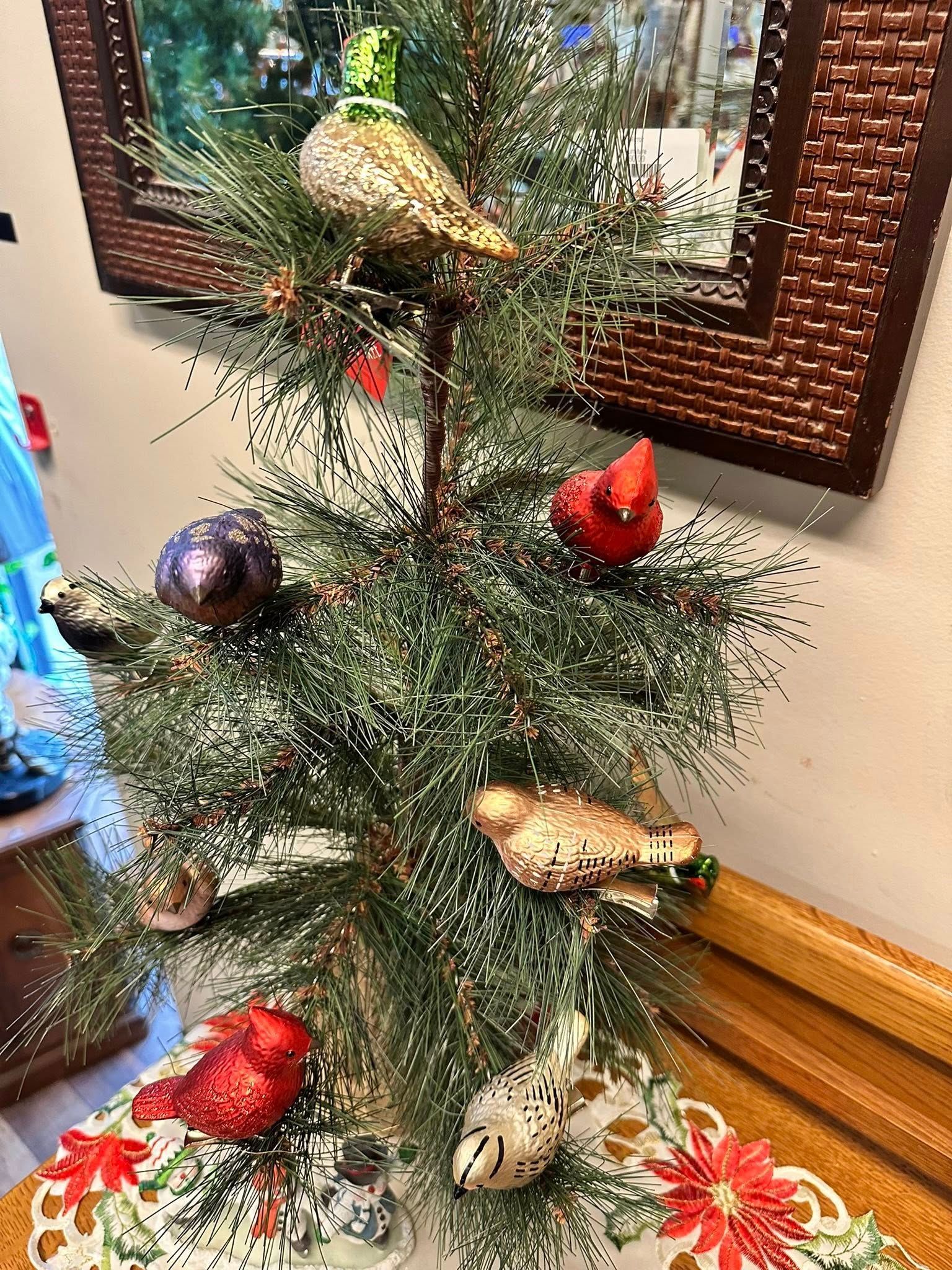 Small Christmas tree decorated with bird ornaments and red cardinals.